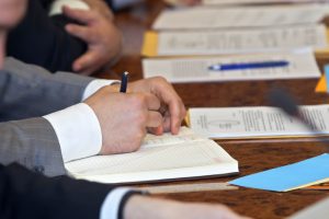 close up of conference meeting businessmen hands - Event Technology for Corporations - The Key to Efficient Planning