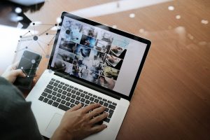 top view of businessman hand working with new modern computer and smart phone and business strategy on wooden desk with social media network as concept - How to Promote an Event Through Online Channels