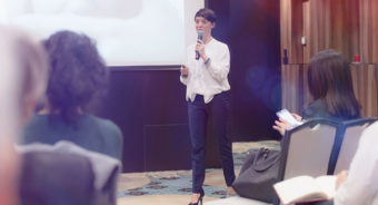 beautiful business woman with microphone in her hand speaking at the conference or seminar e1665040452799 - Top 5 Event Suppliers for Staffing in the UK and Spain